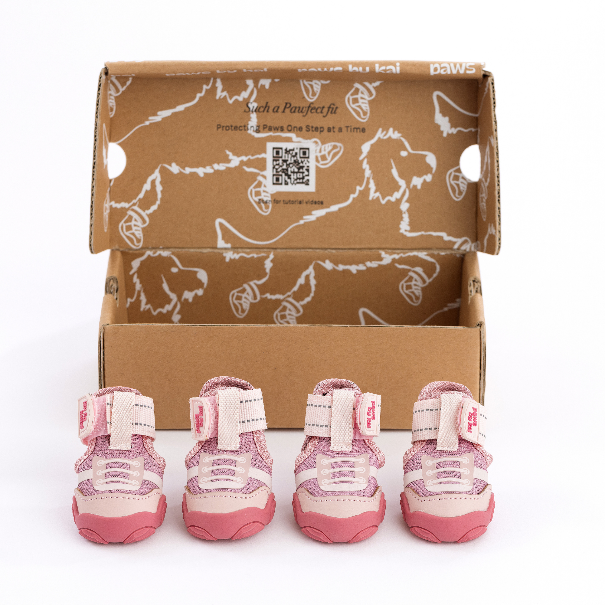 Pink dog sneakers shown in open retail box with four pairs