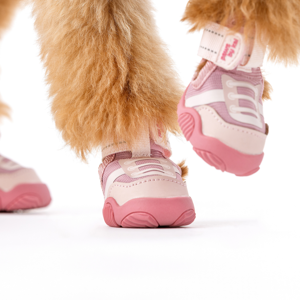 Pink dog sneaker with white lace panel and thick pink rubber sole