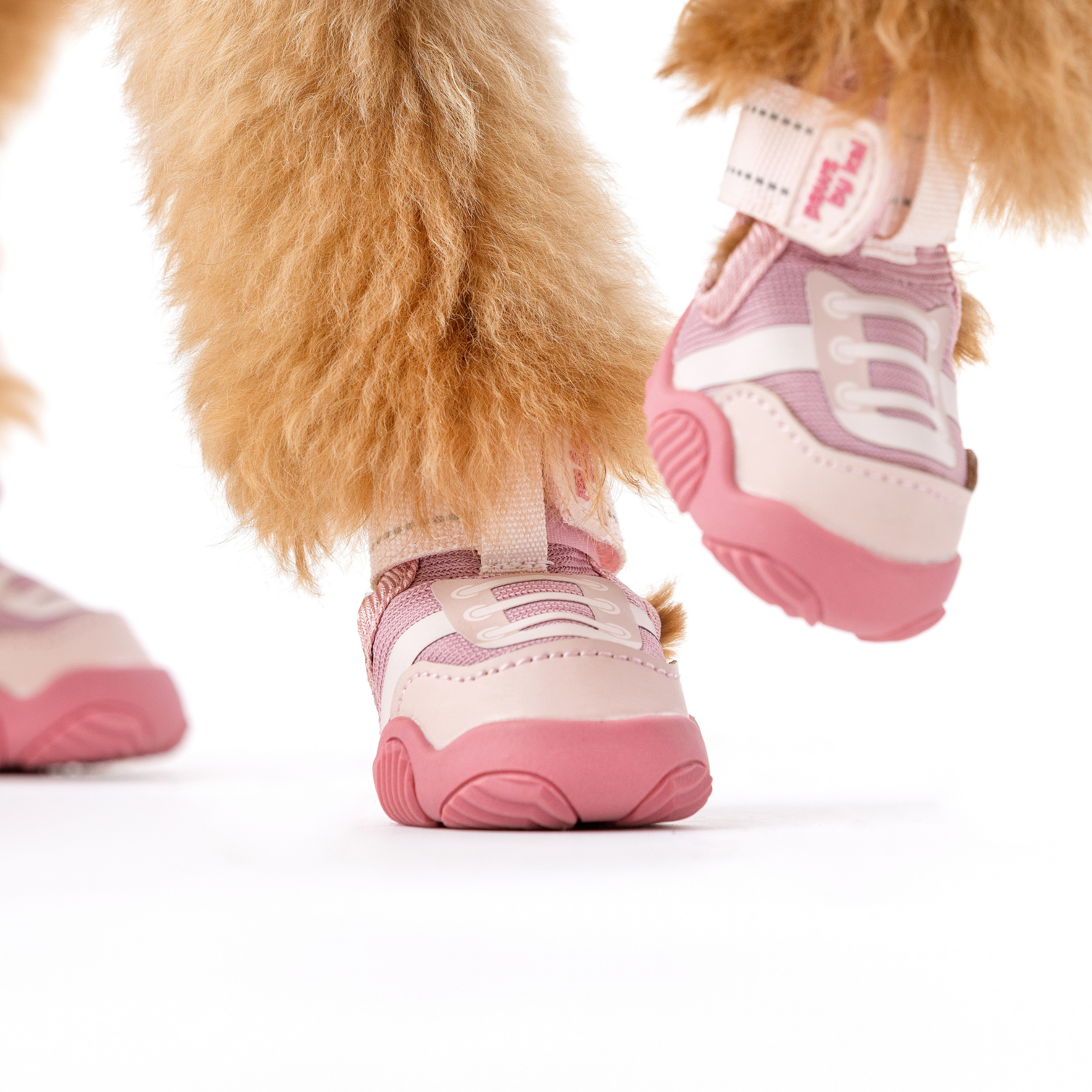 Pink dog sneaker with white lace panel and thick pink rubber sole