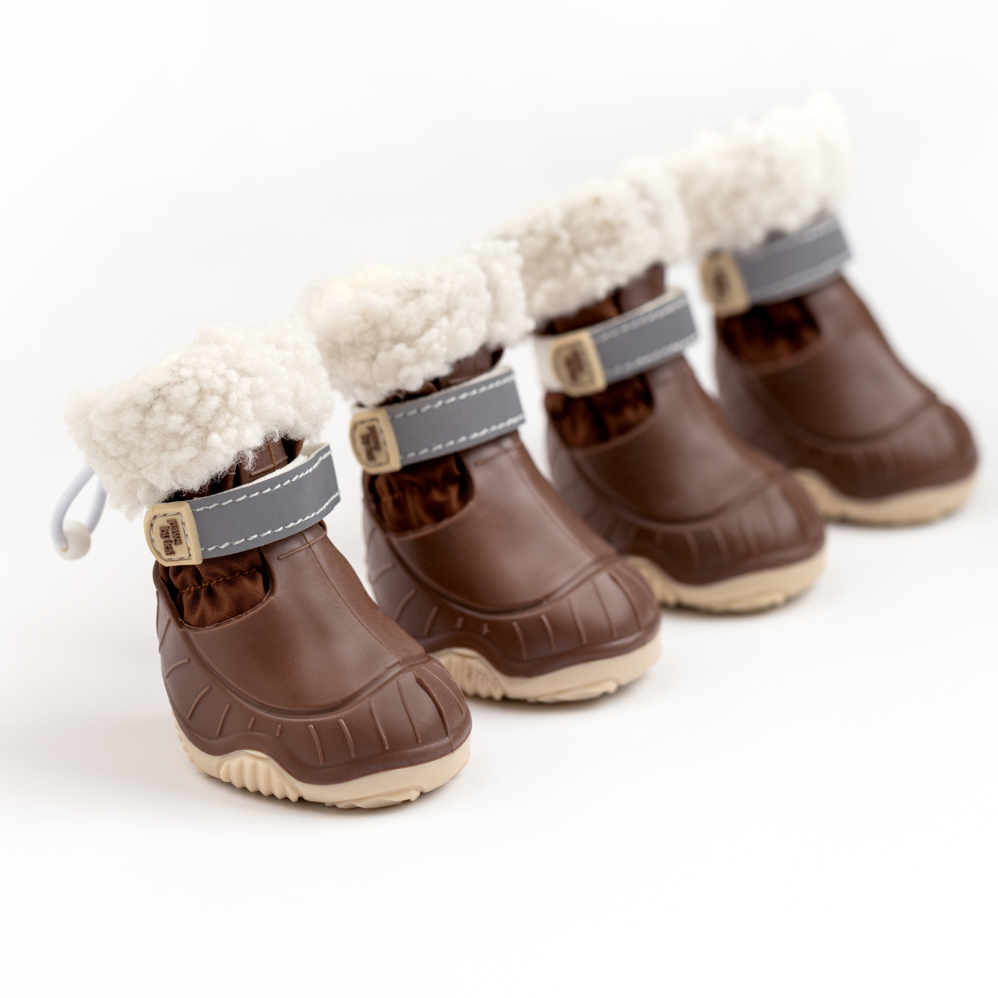 Pair of brown dog snow boots with cream fleece cuffs and gray-blue hook straps