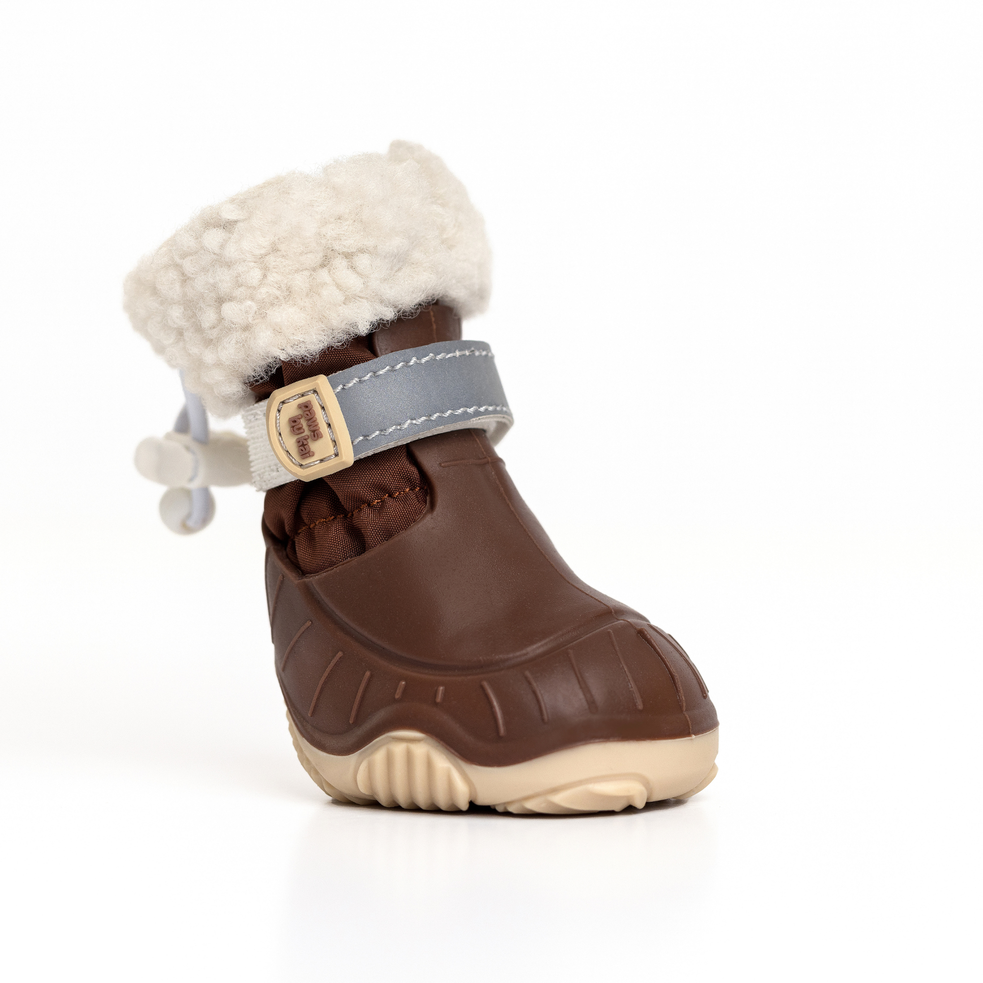 Brown dog snow boot with cream fleece cuff, gray-blue strap, and off-white tread sole