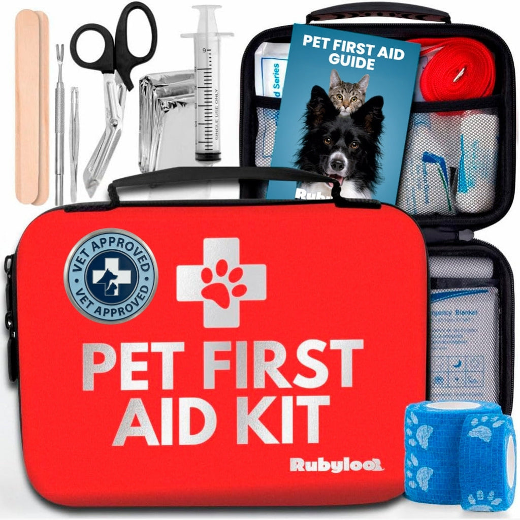 Red pet first aid kit bag with pet guide, roll gauze, and medical tools in compartments