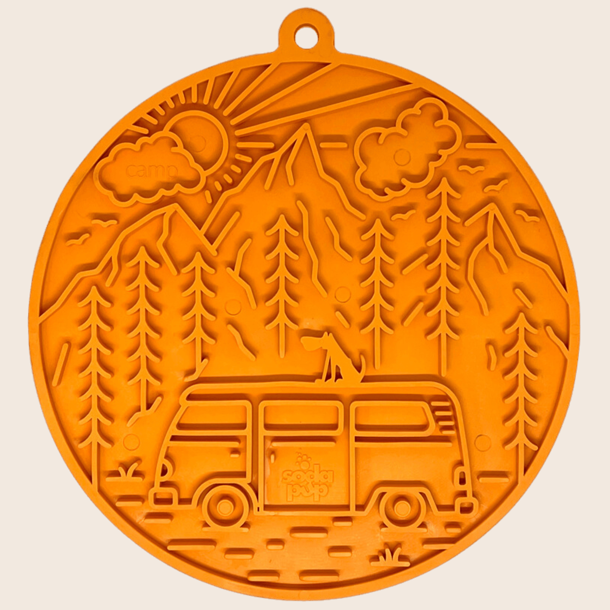 Orange circular dog lick mat with raised forest and train pattern
