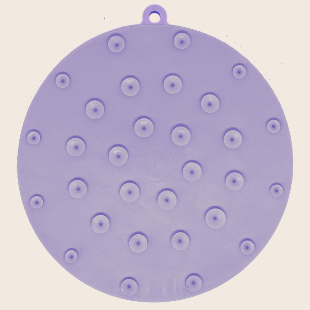 Purple round silicone lick mat with evenly spaced suction bump dots