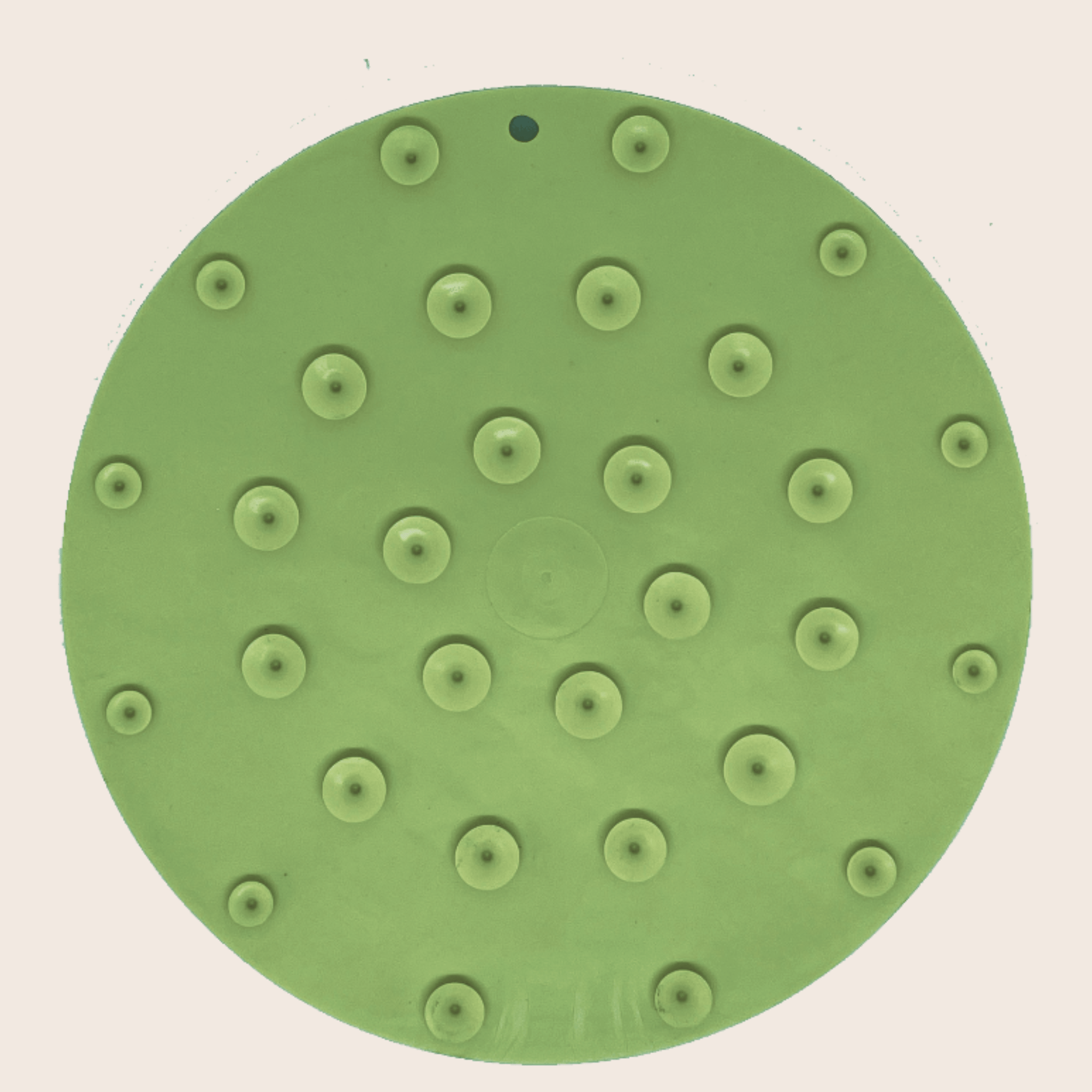 Green round dog lick mat with suction cups and raised circular feeding bumps.