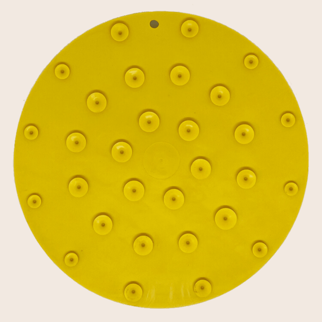 Yellow circular dog lick mat with small suction cup bumps pattern