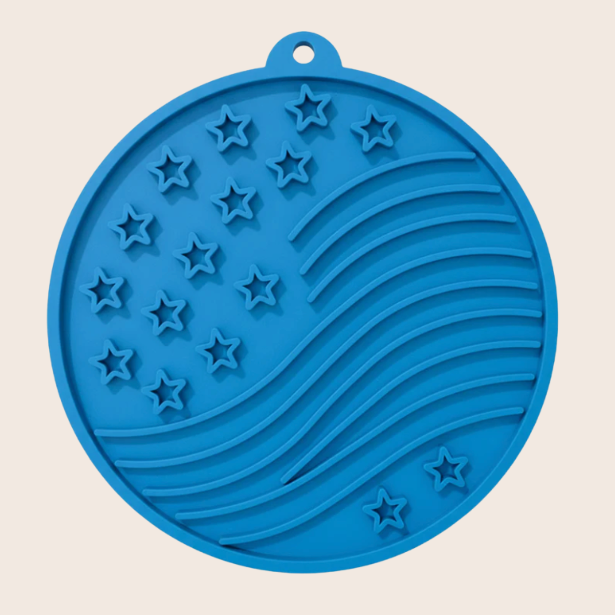 Blue round dog lick mat with raised star pattern and ridged spiral sections.