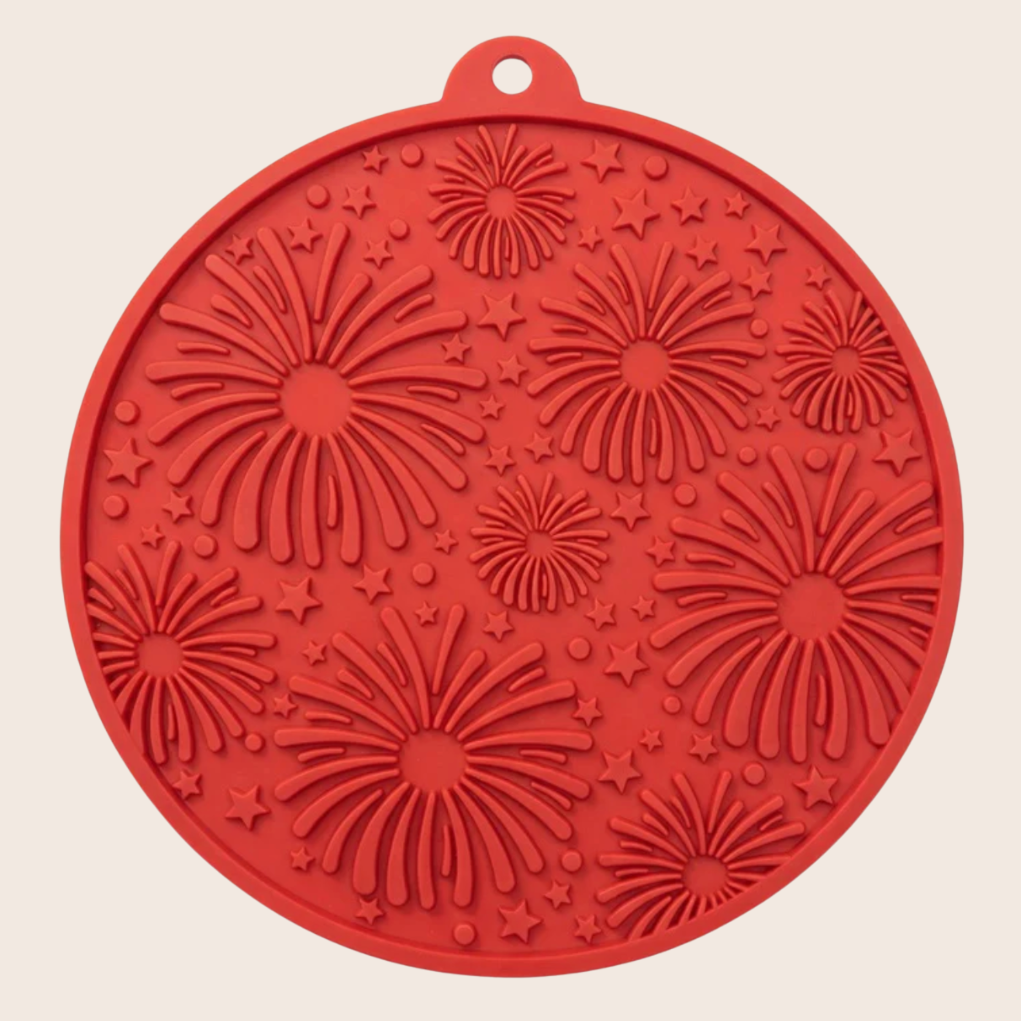 Red round dog lick mat with raised starburst and fireworks-style texture