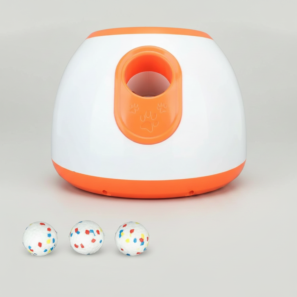 Automatic dog ball launcher with orange top opening and paw-shaped grip, holding three balls