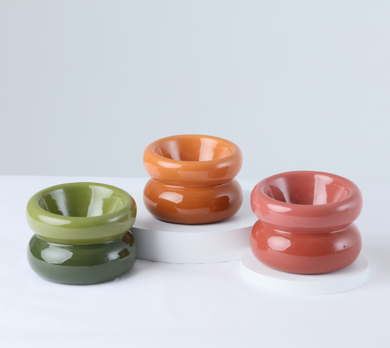 Set of glossy soufflé pet bowls in green, orange, and rose pink
