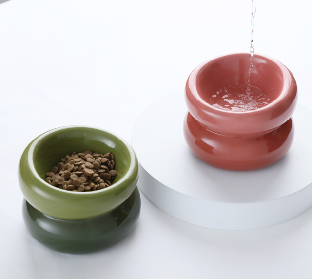 Avocado green soufflé-style pet bowl with kibble inside and water pouring