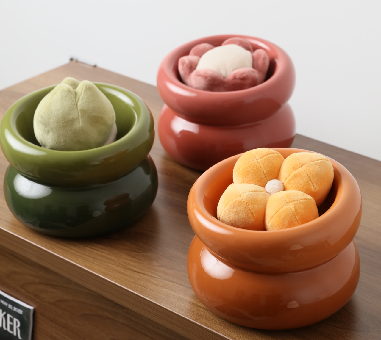Avocado green soufflé-style pet bowl holding a plush toy