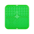 Green silicone lick mat with bone-shaped divider and raised grid plus dot channels