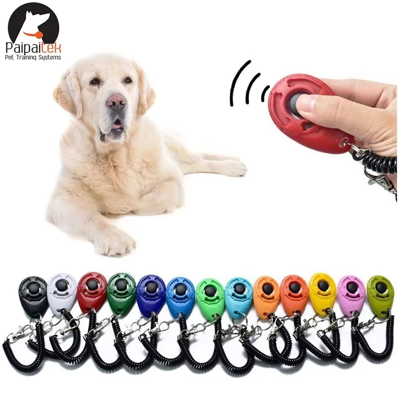 Red teardrop dog training clicker with black coiled wrist strap and metal key ring