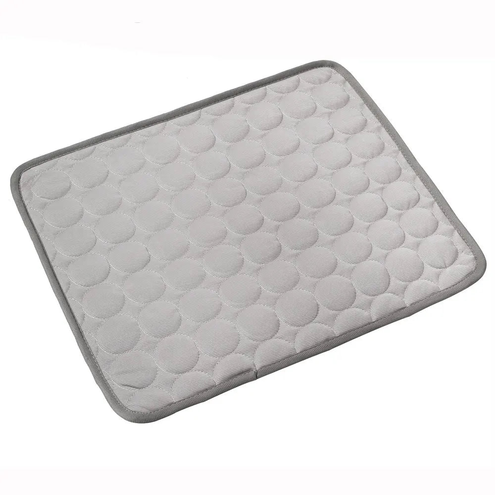 Light gray dog cooling mat with raised bubble pattern and dark border trim