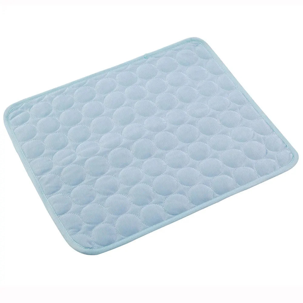 Light blue dog cooling mat with raised bubble pattern and rounded edge stitching
