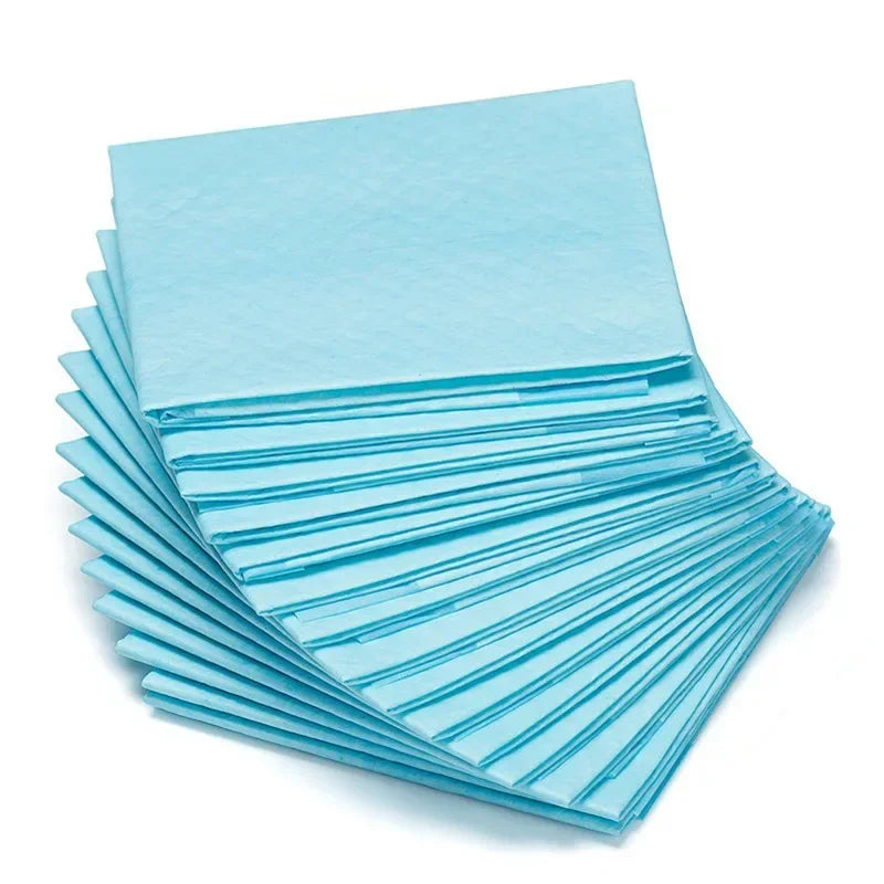 Light blue disposable pet urine pads stacked, with flat unfolded sheets in layers