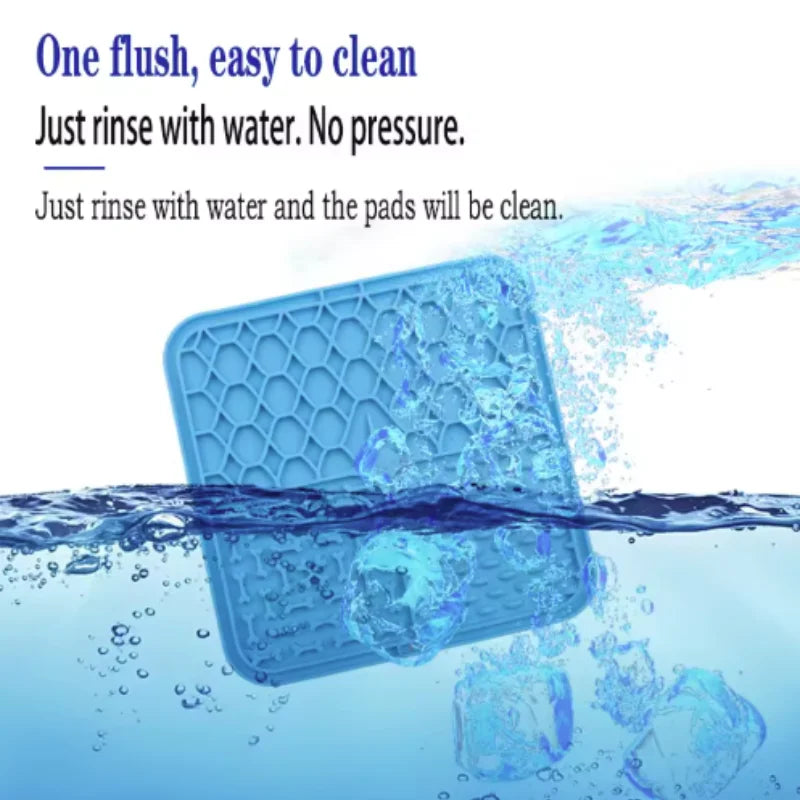 Blue silicone lick mat with raised grooves and bone-shaped channels, with water splashes