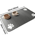 Rectangular dark grey pet feeding mat with white paw prints and two bowls