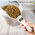 Electronic pet food measuring scoop with LED screen, filled with brown kibble