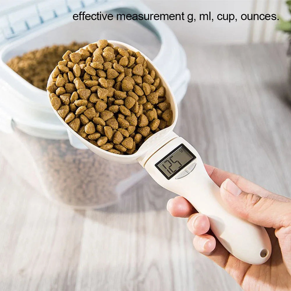 Electronic pet food measuring scoop with LED screen, filled with brown kibble