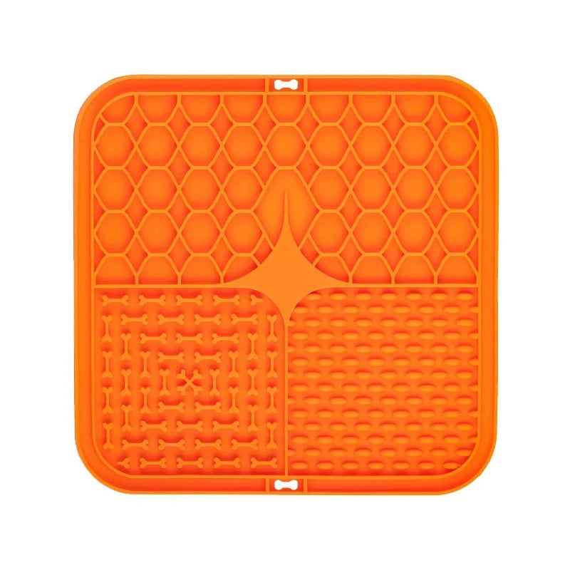 Orange silicone lick mat with bone-shaped divider and raised grid and dot channels