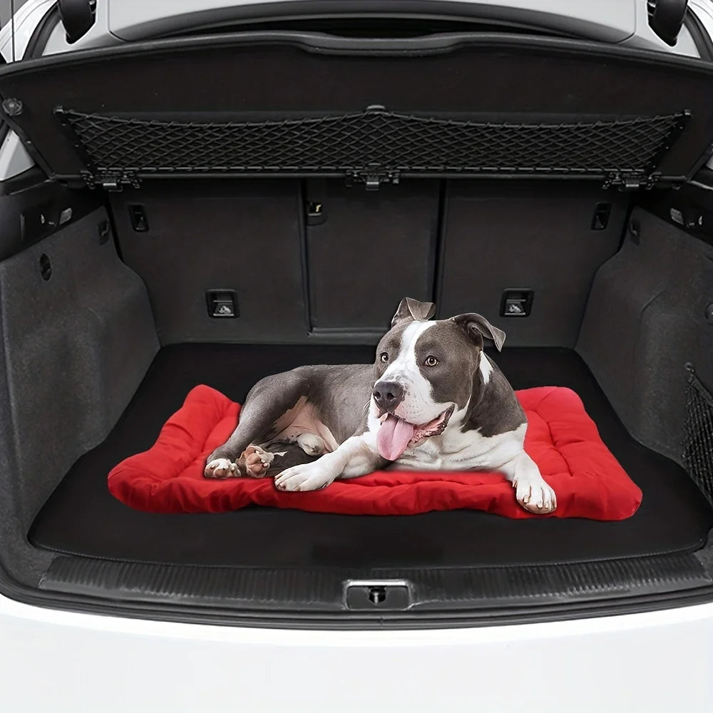Pet bed cushion in red on the car cargo floor, with low rounded edges