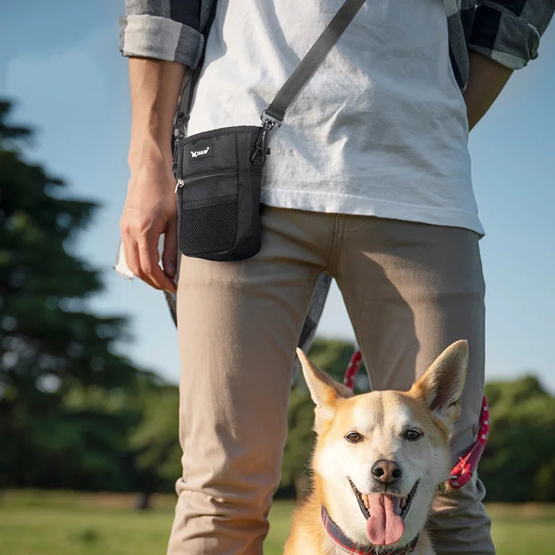 Black waist bag worn at the hip with front mesh treat pocket and strap