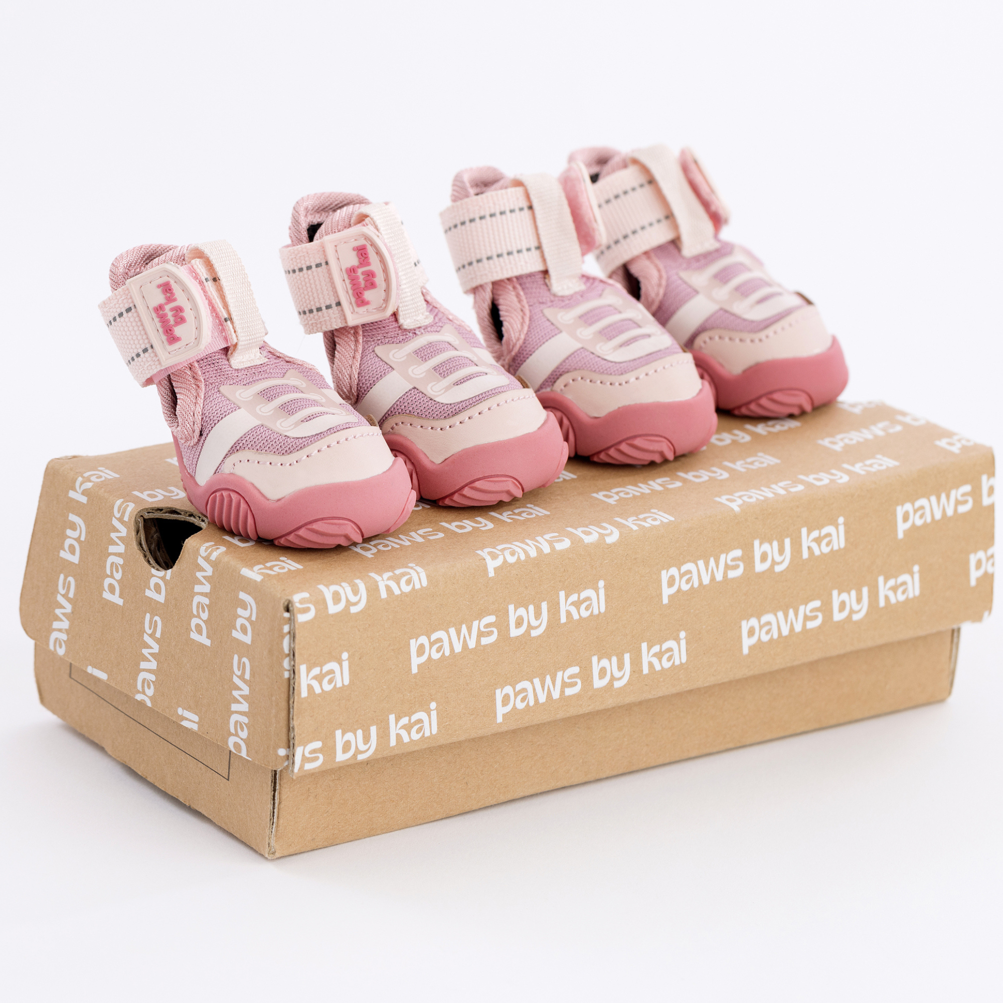 Pink dog sneakers with hook-and-loop straps, logo patch, and cushioned sole